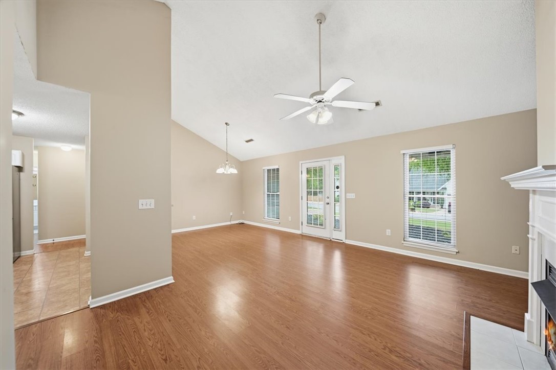 101 Grand Oak Circle Pendleton, SC 29670 - Photo 10 of 40 A spacious living area with warm wood flooring and a classic fireplace offers comfortable gatherings.