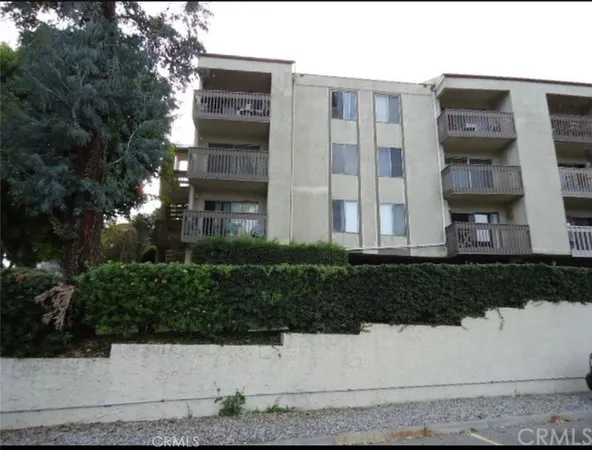 a front view of a residential apartment building with a yard