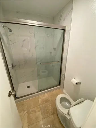 a bathroom with a shower and a toilet