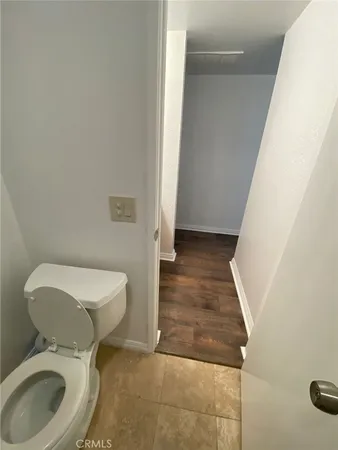 a white toilet sitting next to a shower