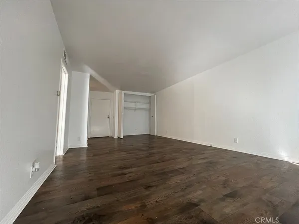 a view of an empty room and wooden floor