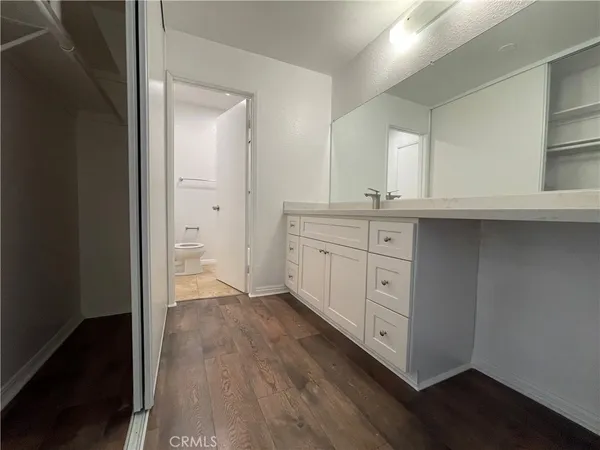 walk in closet with wooden floor