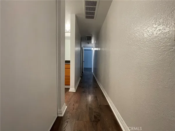 a view of hallway with wooden floor