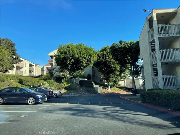 a view of a cars parked on the side of a street
