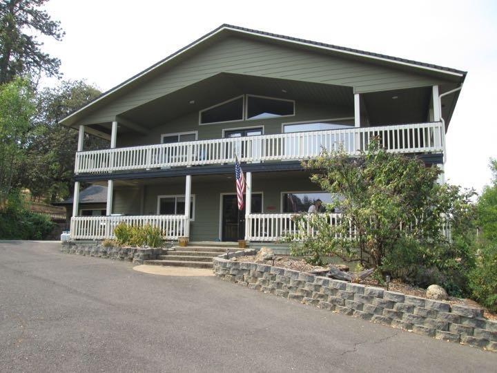 4419 Old Stage Road Central Point, OR 97502 - Photo 1 of 12 a front view of a house with garden