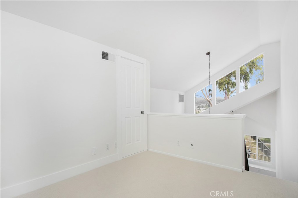 20006 Shamrock, Unit 10 Lake Forest, CA 92630 - Photo 20 of 25 a hallway with stairs and wooden floor