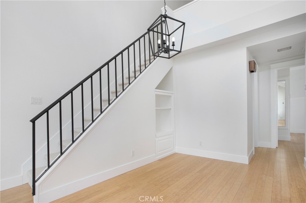 20006 Shamrock, Unit 10 Lake Forest, CA 92630 - Photo 6 of 25 a view of staircase with wooden floor and white walls