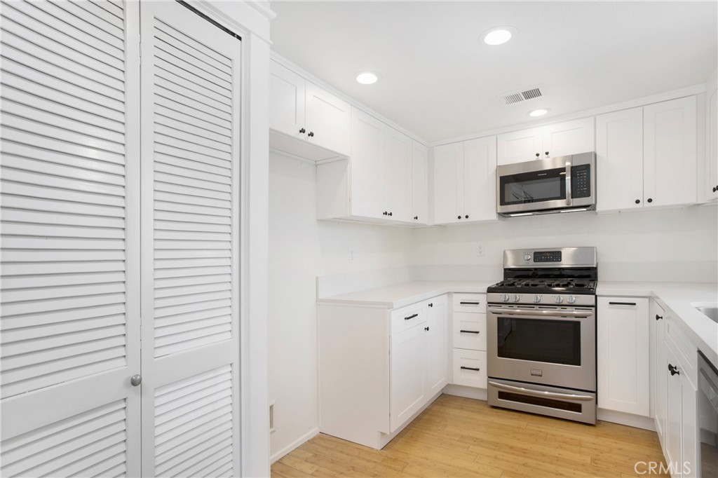 20006 Shamrock, Unit 10 Lake Forest, CA 92630 - Photo 8 of 25 a kitchen with a stove and a microwave