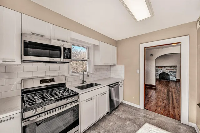a kitchen with stainless steel appliances a stove a microwave and cabinets