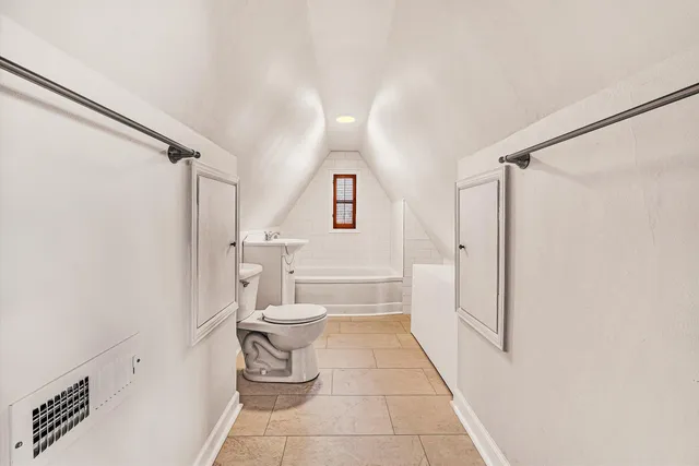 a bathroom with a toilet a sink and shower