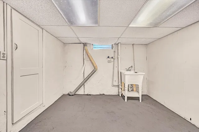 a view of a room with table and white chairs