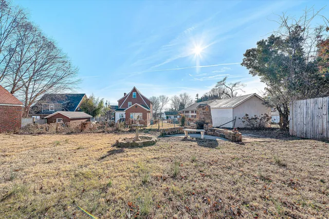 a wooden bench sitting in middle of a yard