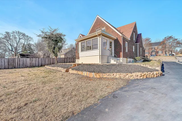 a front view of a house with a yard covered with snow