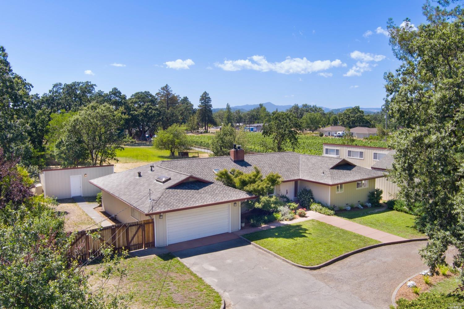a view of a house with a yard and sitting area