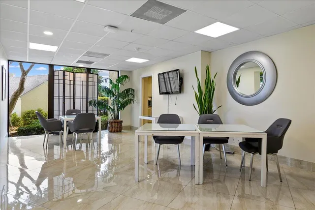 a living room with furniture a chandelier and a large window