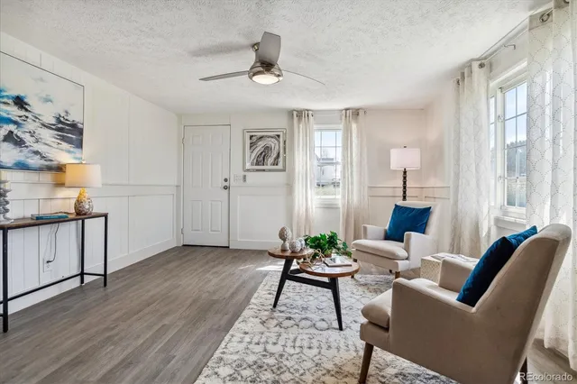 a living room with furniture and wooden floor