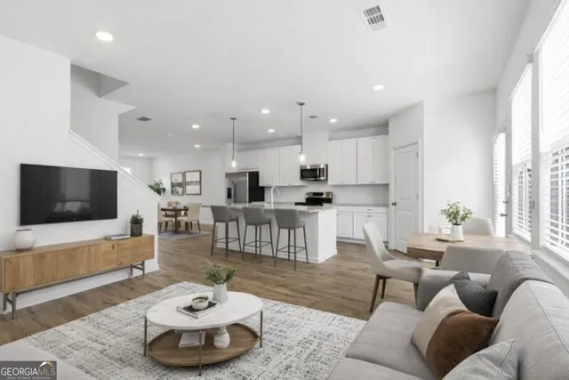 a living room with furniture and a flat screen tv