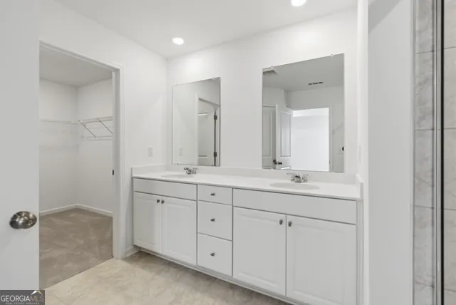 a bathroom with double sink and a mirror