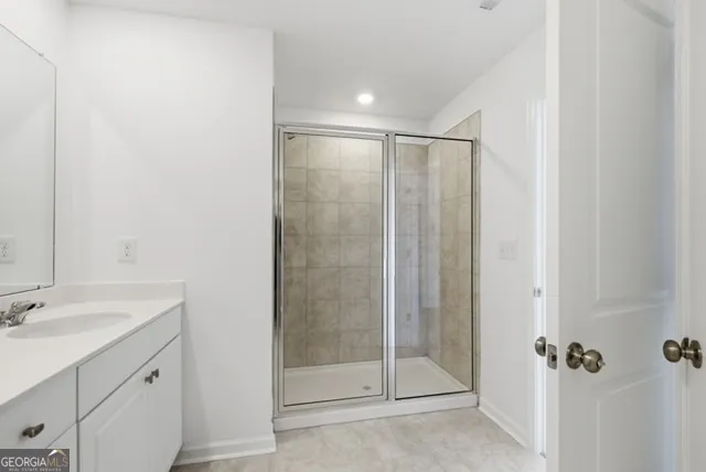 a bathroom with a shower and a sink