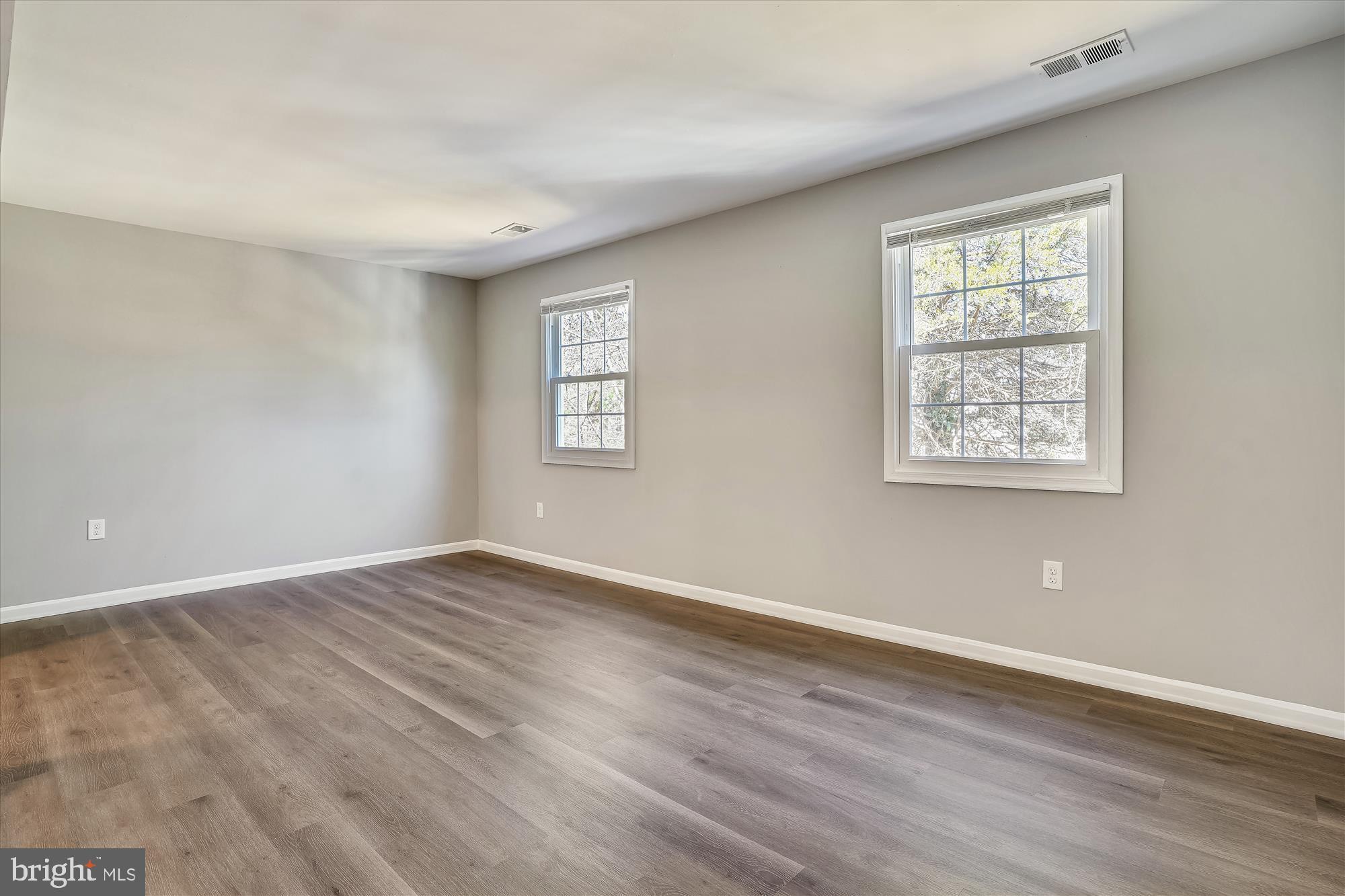 9202 Sprucewood Road Burke, VA 22015 - Photo 13 of 21 a view of an empty room with wooden floor and a window