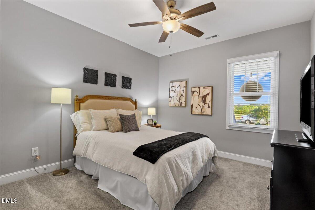 88 Heath Road Lillington, NC 27546 - Photo 16 of 54 a bedroom with a large bed and a flat tv screen on dresser