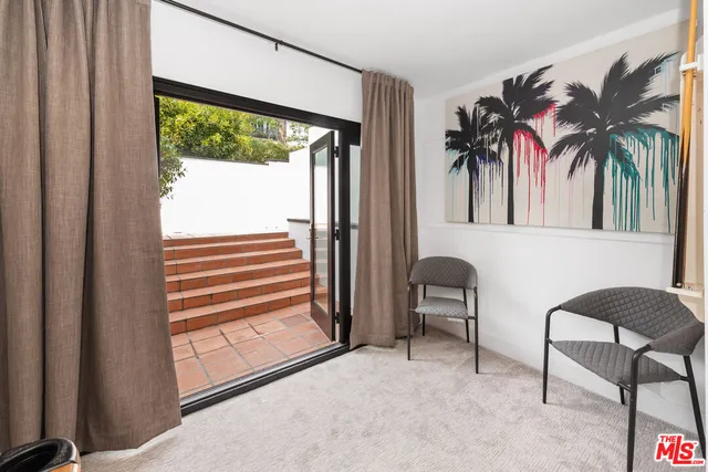 a view of a livingroom with furniture and a window