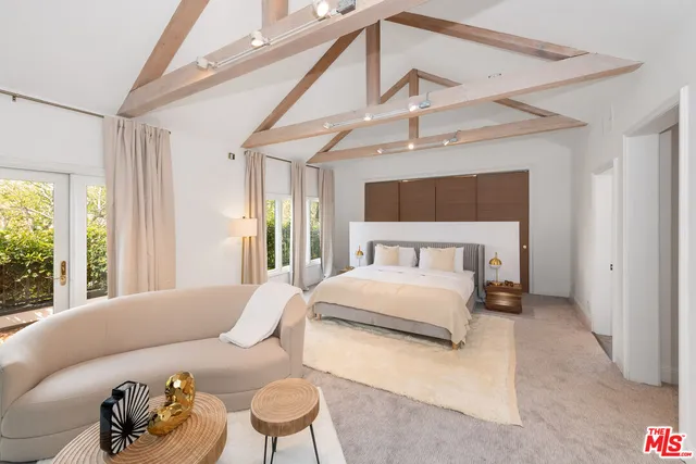 a bedroom with a bed couch and window