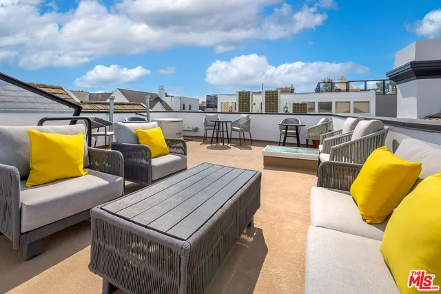 a view of a swimming pool with couches chairs