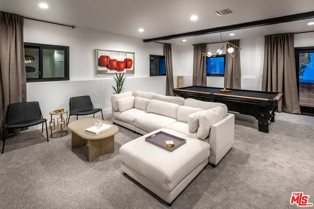 a living room with furniture and a piano