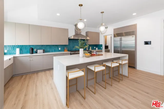 a kitchen with a table chairs and wooden floor