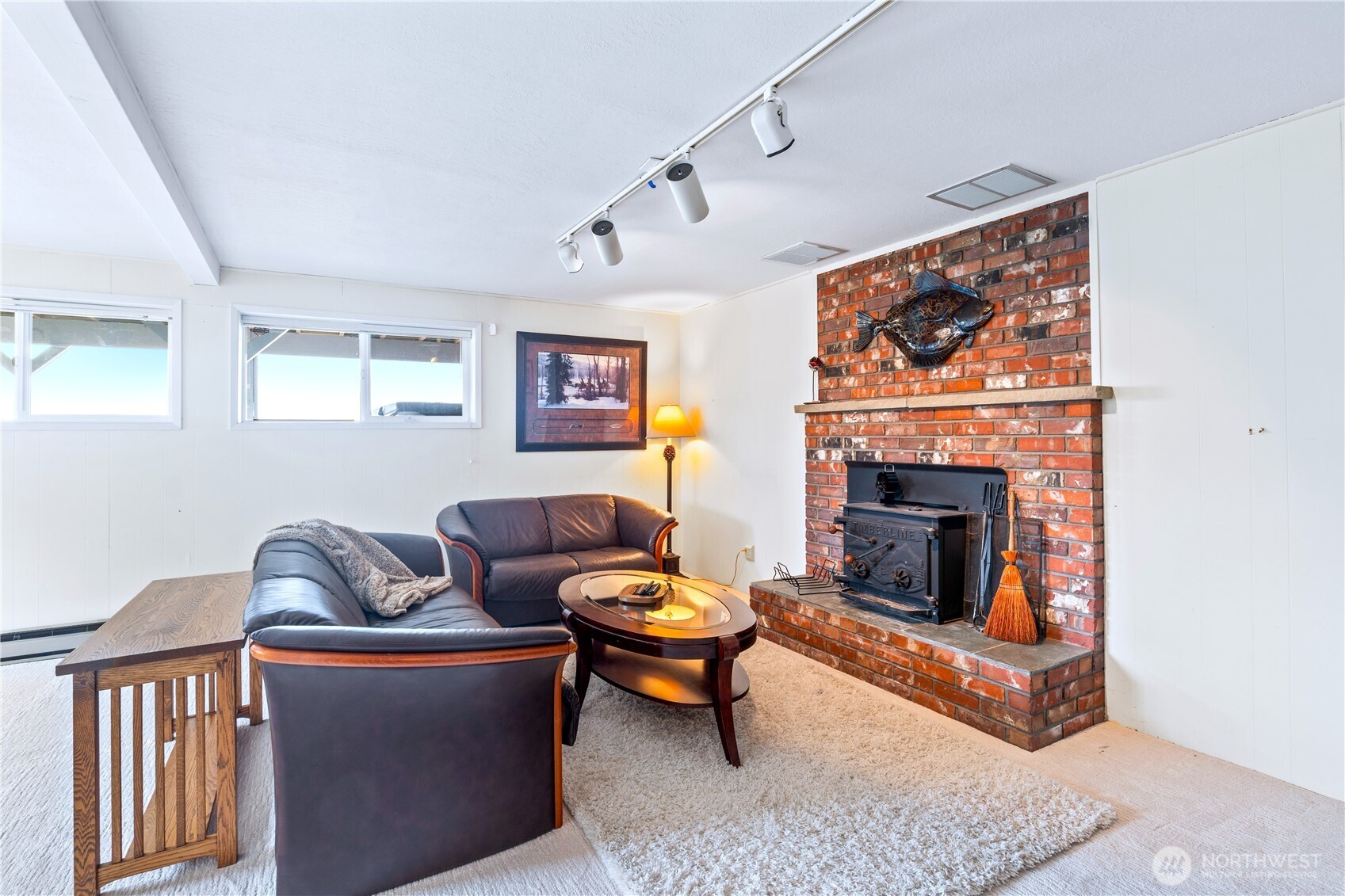 9609 Samish Island Road Bow, WA 98232 - Photo 16 of 33 a living room with furniture a rug and a fireplace