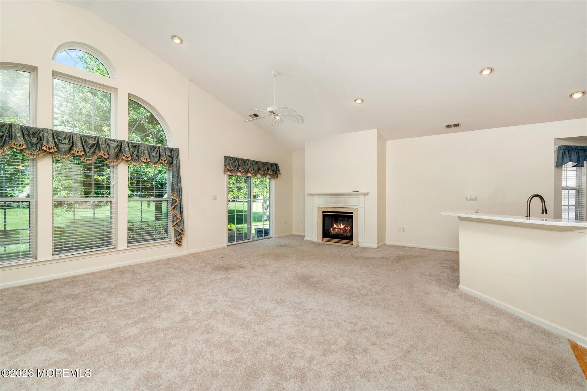 10 Powderhorn Way Allentown, NJ 08501 - Photo 7 of 27 a view of an empty room with a fireplace and a large window