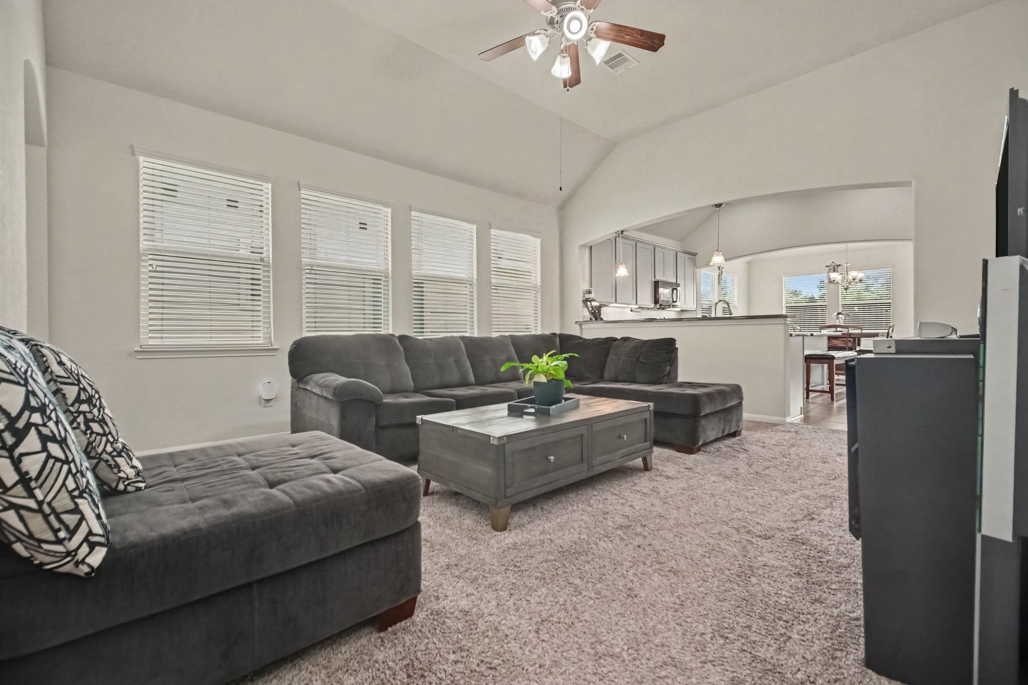 14219 Rim Side Trail Houston, TX 77045 - Photo 4 of 21 This great living room feels bright and airy with high ceilings and wall of windows!