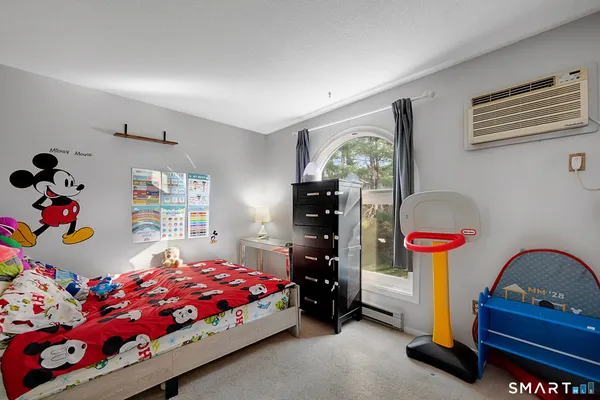 a bedroom with bed and a window