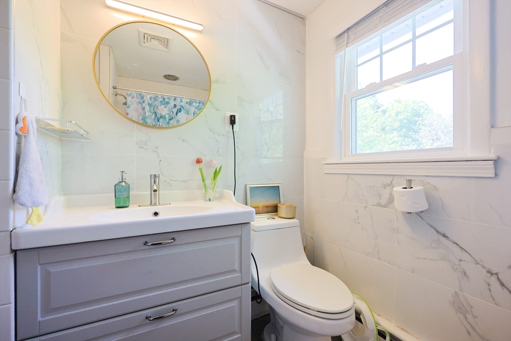 18 Tilden Road Canton, MA 02021 - Photo 16 of 30 a bathroom with a toilet a sink and mirror