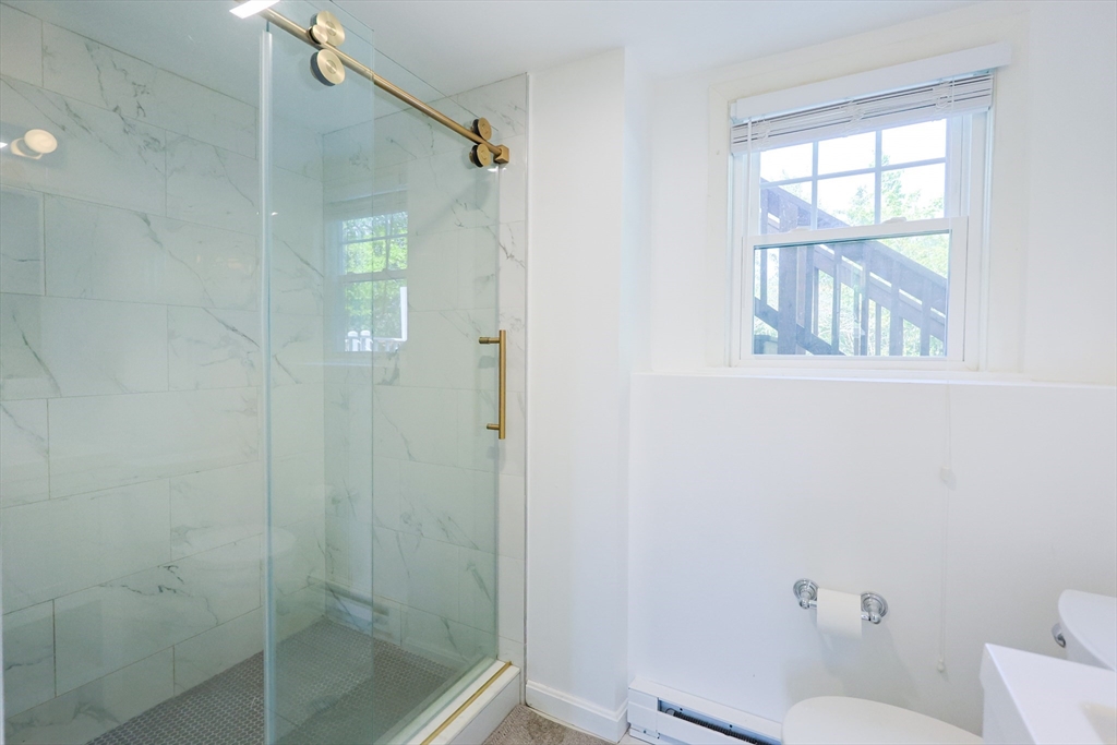 18 Tilden Road Canton, MA 02021 - Photo 20 of 30 a bathroom with a shower and toilet