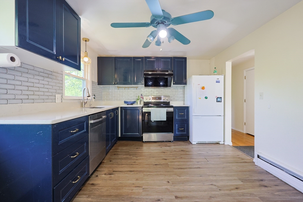 18 Tilden Road Canton, MA 02021 - Photo 6 of 30 a kitchen with stainless steel appliances granite countertop a refrigerator a sink dishwasher a stove and a microwave oven with cabinets