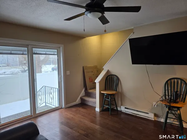 a view of a livingroom with furniture and a window