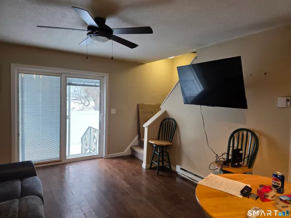 a view of a workspace with furniture and a flat screen tv