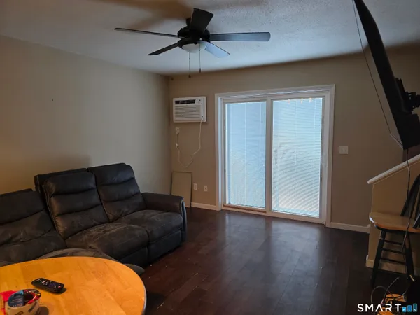 a living room with furniture and a wooden floor