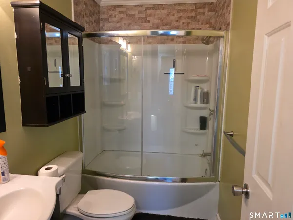 a white toilet sitting next to a bathroom sink
