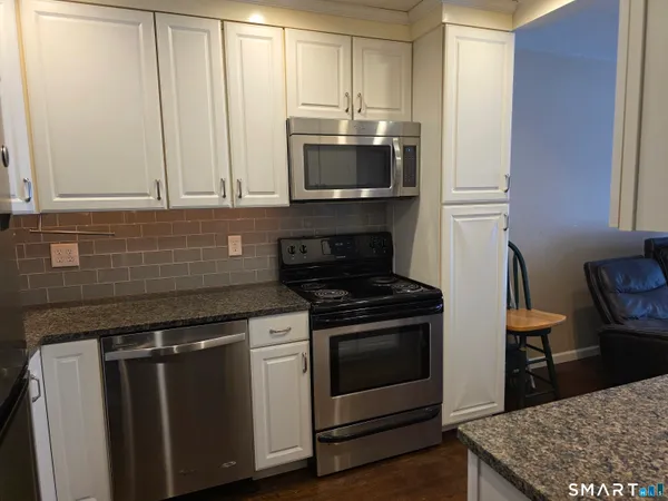 a kitchen with a stove and a microwave