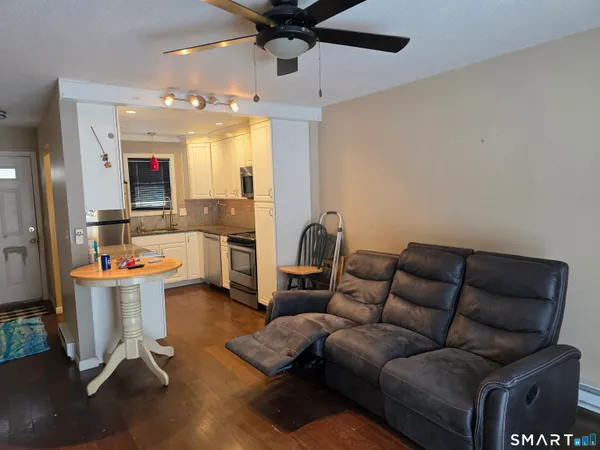 a living room with furniture and a chandelier
