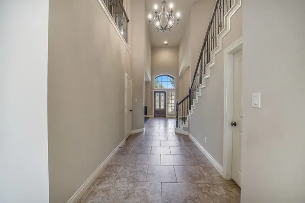 a view of a hallway with a chandelier