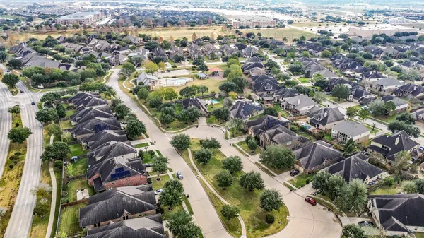 an aerial view of residential houses with outdoor space