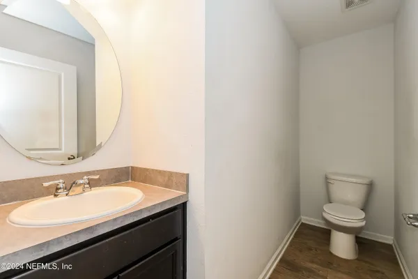 a bathroom with a sink toilet and a mirror