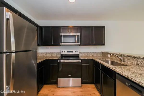 a kitchen with a sink stove and refrigerator