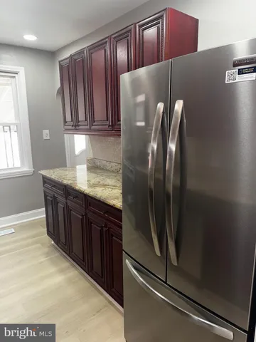 a kitchen with stainless steel appliances granite countertop a refrigerator and a sink