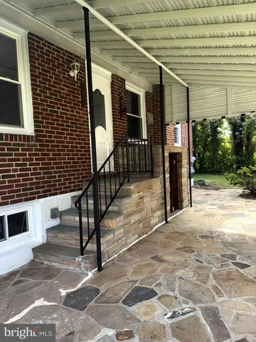 a view of a patio with table and chairs and potted plants