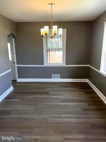 a view of room with window and wooden floor